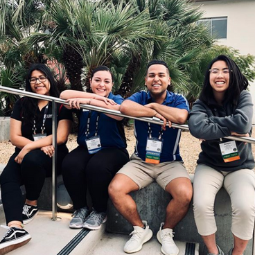 People leaning on a railing